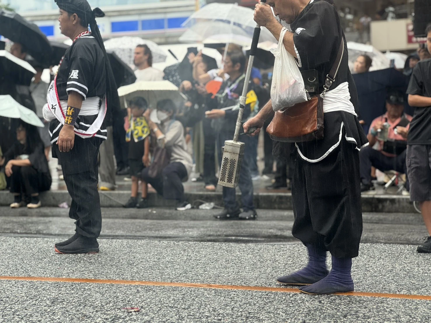 雨の中で爆竹を担当する参加者
