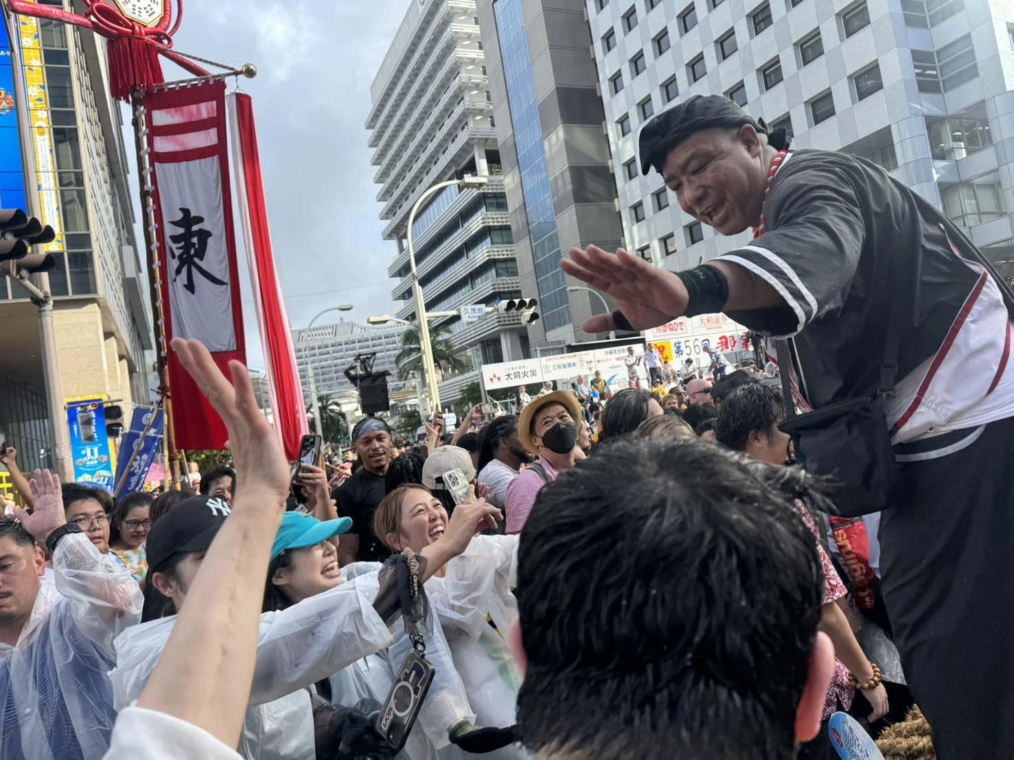 大綱の上の担当者とハイタッチを交わす参加者